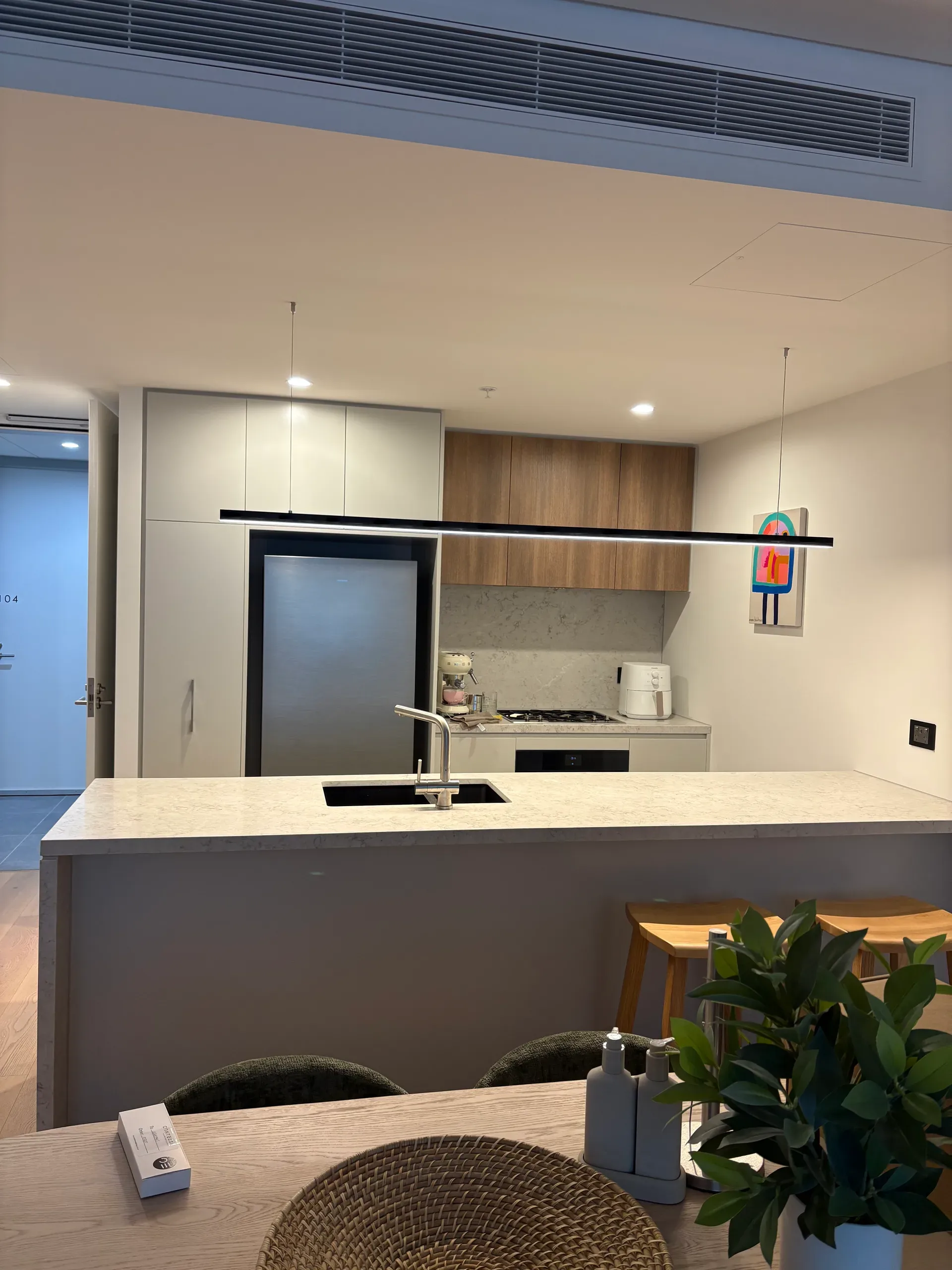 Linear pendant over island